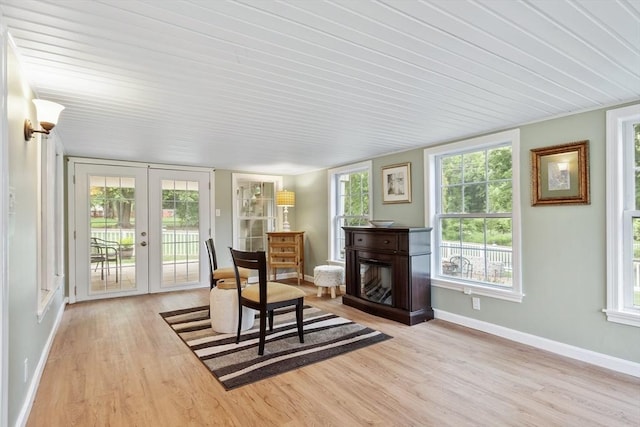 9 New Meadow Rd, Lynnfield, MA 01940 - sitting room with french doors, light wood-type flooring, a glass covered fireplace, and wood ceiling