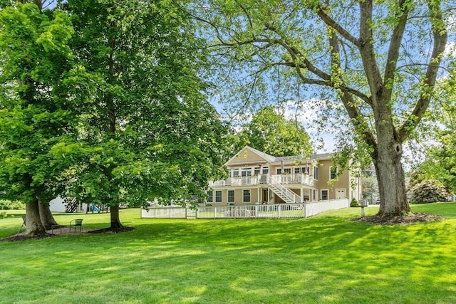 9 New Meadow Rd, Lynnfield, MA 01940 - rear view of property with stairs, a lawn, and a deck