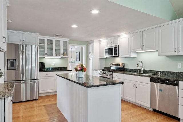 9 New Meadow Rd, Lynnfield, MA 01940 - kitchen featuring appliances with stainless steel finishes, white cabinetry, light wood finished floors, a kitchen island, and recessed lighting
