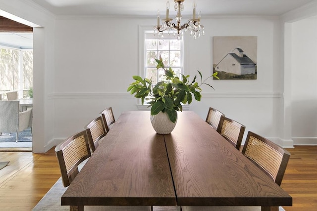 159 Payson Rd, Brookline, MA 02467 - dining area featuring a chandelier, wood finished floors, crown molding, and baseboards