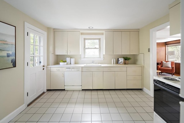 159 Payson Rd, Brookline, MA 02467 - kitchen with white appliances, a sink, light countertops, baseboards, and cream cabinets