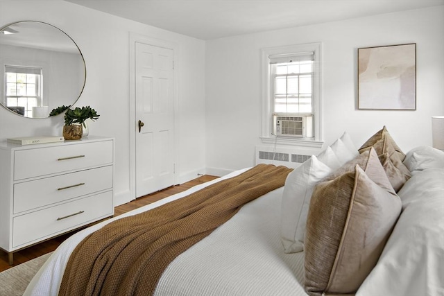 159 Payson Rd, Brookline, MA 02467 - bedroom featuring dark wood-style floors, cooling unit, radiator, and baseboards