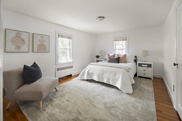 159 Payson Rd, Brookline, MA 02467 - bedroom featuring radiator heating unit, wood finished floors, and baseboards