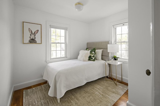 159 Payson Rd, Brookline, MA 02467 - bedroom with multiple windows, baseboards, and wood finished floors
