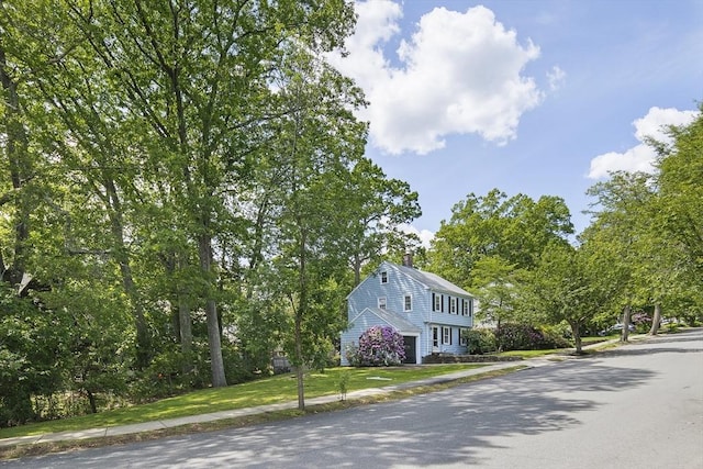 159 Payson Rd, Brookline, MA 02467 - view of front facade with an attached garage, a front yard, and a chimney