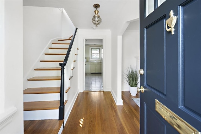 159 Payson Rd, Brookline, MA 02467 - foyer entrance with stairs, baseboards, dark wood finished floors, and ornamental molding