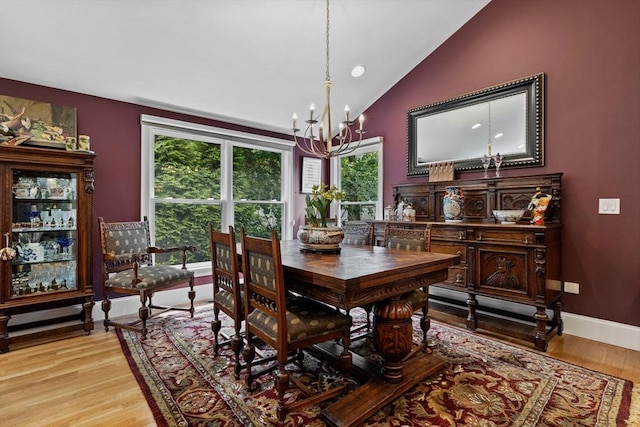 1488 Washington St Unit 1488, Newton, MA 02465 - dining area featuring a chandelier, vaulted ceiling, light wood-style floors, and baseboards