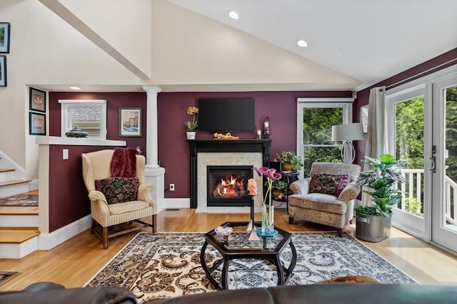 1488 Washington St Unit 1488, Newton, MA 02465 - living area with a glass covered fireplace, decorative columns, wood finished floors, high vaulted ceiling, and recessed lighting