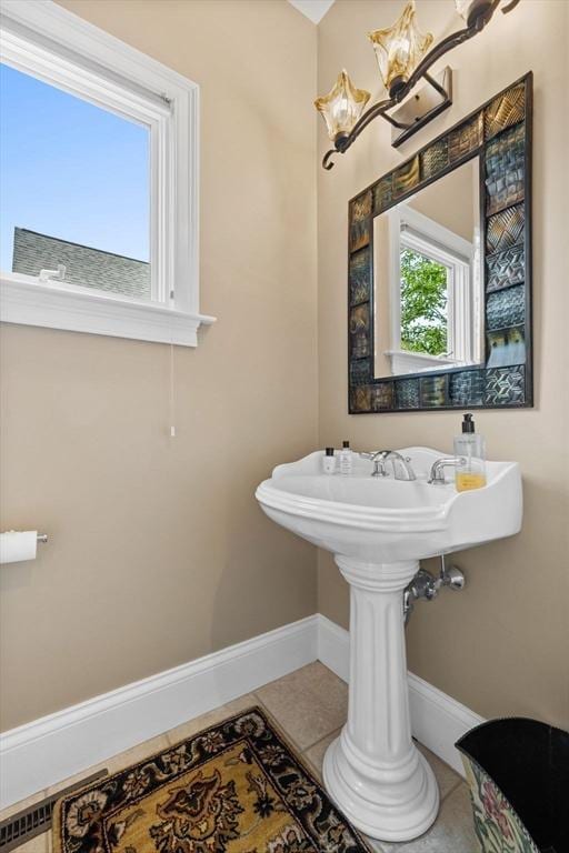 1488 Washington St Unit 1488, Newton, MA 02465 - bathroom featuring baseboards, tile patterned floors, and a chandelier