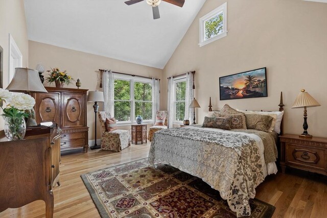1488 Washington St Unit 1488, Newton, MA 02465 - bedroom with high vaulted ceiling, wood finished floors, and ceiling fan