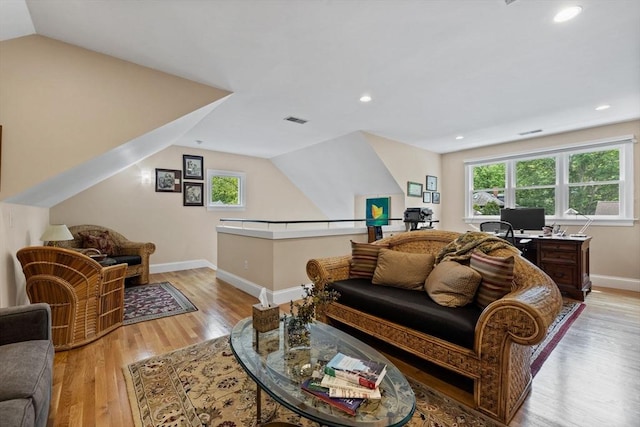 1488 Washington St Unit 1488, Newton, MA 02465 - living area featuring vaulted ceiling, healthy amount of natural light, a desk, baseboards, and light wood-type flooring