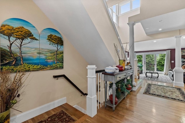 1488 Washington St Unit 1488, Newton, MA 02465 - stairway featuring decorative columns, baseboards, and wood finished floors