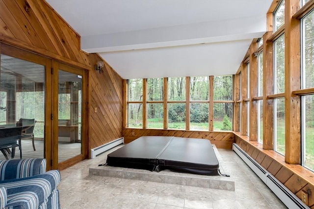 sunroom featuring a baseboard radiator, plenty of natural light, and wooden walls