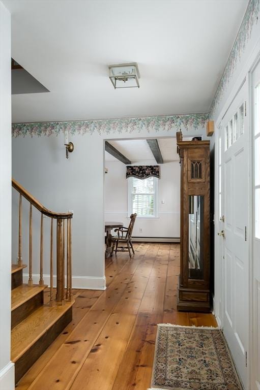 foyer featuring light wood-style floors, stairs, and baseboards
