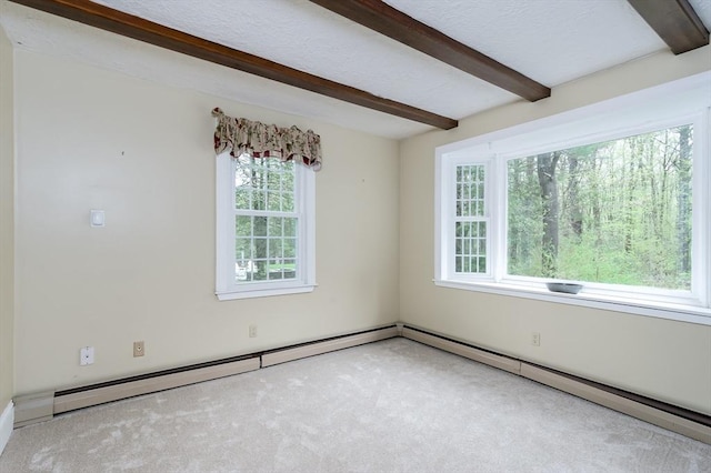 unfurnished room featuring beam ceiling, healthy amount of natural light, and carpet floors
