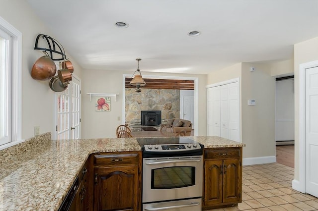 kitchen with stainless steel range with electric stovetop, plenty of natural light, light tile patterned floors, and recessed lighting