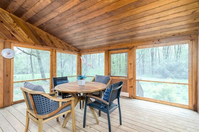 sunroom featuring lofted ceiling, hardwood / wood-style floors, a deck, outdoor dining area, and wood ceiling