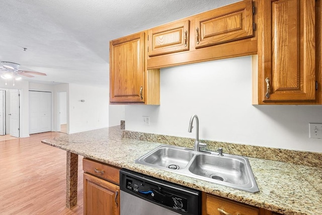 39 Parlin St Unit 503, Everett, MA 02149 - kitchen with a sink, stainless steel dishwasher, light wood finished floors, a ceiling fan, and brown cabinetry
