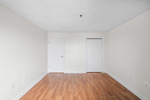 39 Parlin St Unit 503, Everett, MA 02149 - unfurnished bedroom featuring baseboards, light wood-style floors, and a closet