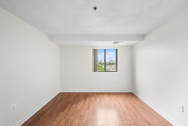 39 Parlin St Unit 503, Everett, MA 02149 - spare room featuring wood finished floors, a pendent fire sprinkler, and baseboards