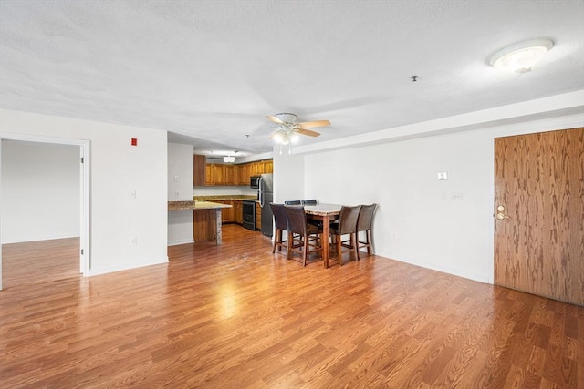 39 Parlin St Unit 503, Everett, MA 02149 - dining space featuring a ceiling fan, light wood-style floors, and baseboards
