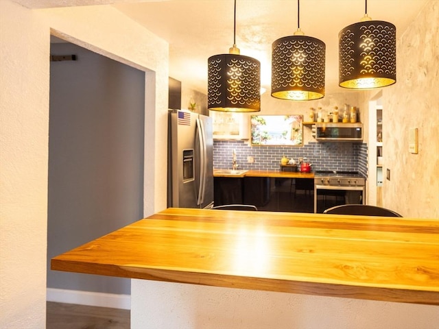 382 Great Rd Unit B 203, Acton, MA 01720 - kitchen featuring stainless steel appliances, backsplash, butcher block countertops, and baseboards