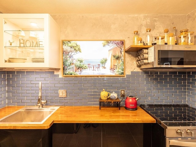 382 Great Rd Unit B 203, Acton, MA 01720 - kitchen featuring stainless steel appliances, butcher block counters, and tasteful backsplash