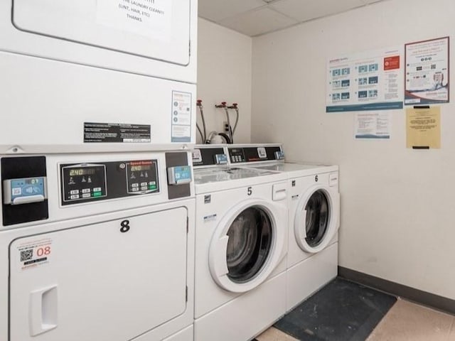 382 Great Rd Unit B 203, Acton, MA 01720 - communal laundry room featuring stacked washer / drying machine, washer and dryer, and baseboards
