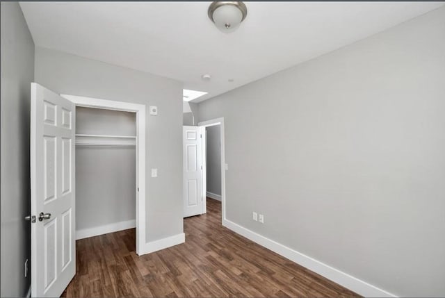 1907 Columbus Ave, Boston, MA 02119 - unfurnished bedroom featuring baseboards, wood finished floors, and a closet