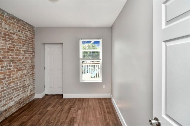 1907 Columbus Ave, Boston, MA 02119 - unfurnished room featuring brick wall, wood finished floors, and baseboards