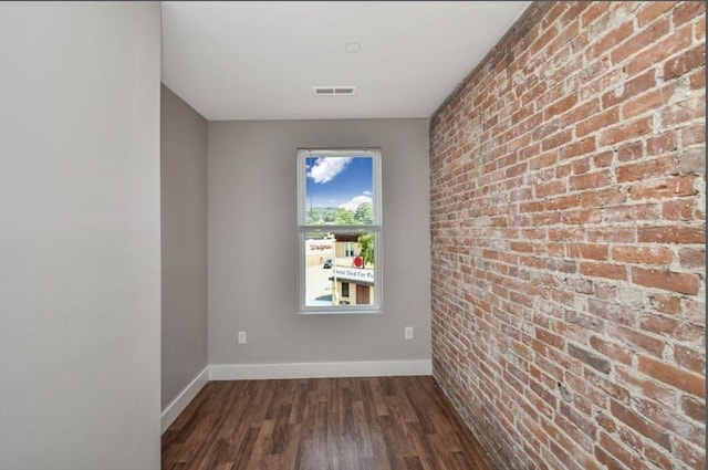 1907 Columbus Ave, Boston, MA 02119 - unfurnished room with baseboards, dark wood-style flooring, and brick wall