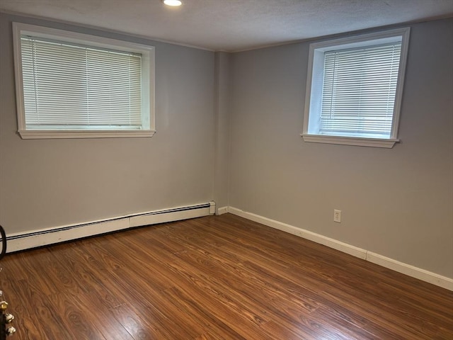 64 Bryon Rd Unit 1, Boston, MA 02467 - spare room featuring a baseboard heating unit, dark wood-style flooring, and recessed lighting