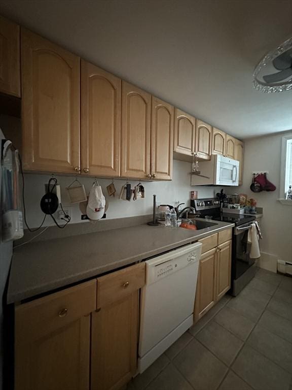 64 Bryon Rd Unit 1, Boston, MA 02467 - kitchen featuring white appliances, light tile patterned floors, light brown cabinets, light countertops, and a baseboard heating unit