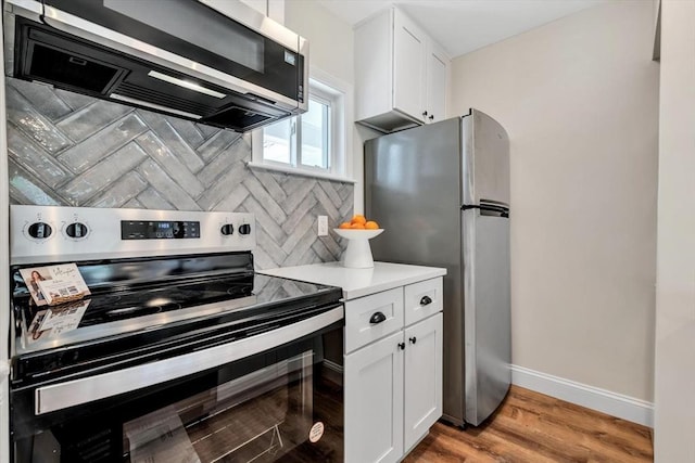 81 Fletcher Ln Unit I, Brewster, MA 02631 - kitchen with appliances with stainless steel finishes, white cabinetry, light countertops, and light wood finished floors