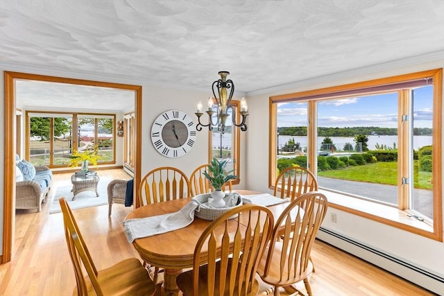 5 S Blvd, Wareham, MA 02558 - dining space with a baseboard radiator, a chandelier, light wood-style floors, and a water view