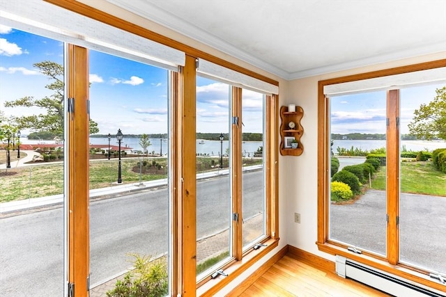 5 S Blvd, Wareham, MA 02558 - doorway to outside featuring a baseboard heating unit, a water view, crown molding, baseboards, and plenty of natural light
