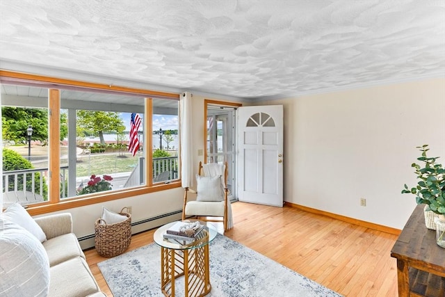 5 S Blvd, Wareham, MA 02558 - living room featuring a baseboard radiator, hardwood / wood-style floors, baseboards, and crown molding