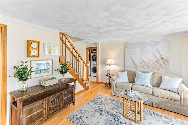 5 S Blvd, Wareham, MA 02558 - living area with stacked washer / drying machine, stairway, crown molding, and light wood-type flooring
