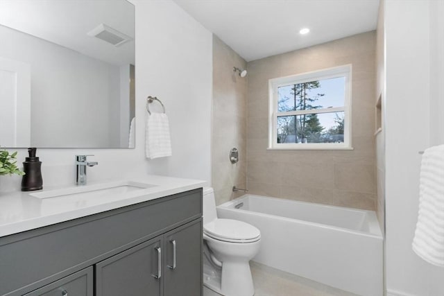 full bathroom with vanity, toilet, and tiled shower / bath combo