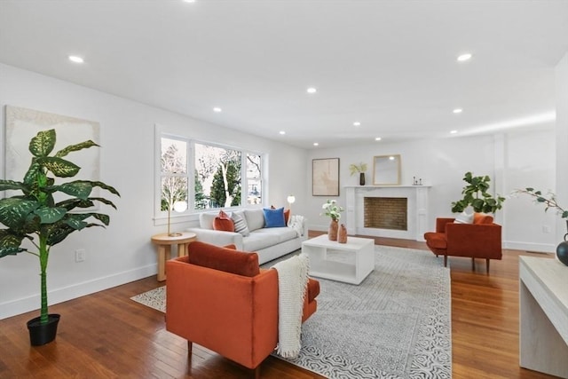 living room with hardwood / wood-style flooring and a high end fireplace