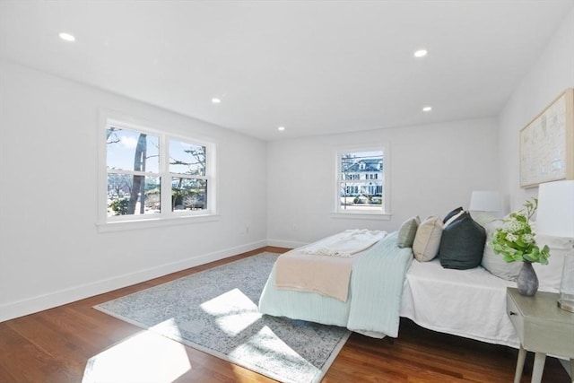 bedroom with dark hardwood / wood-style flooring