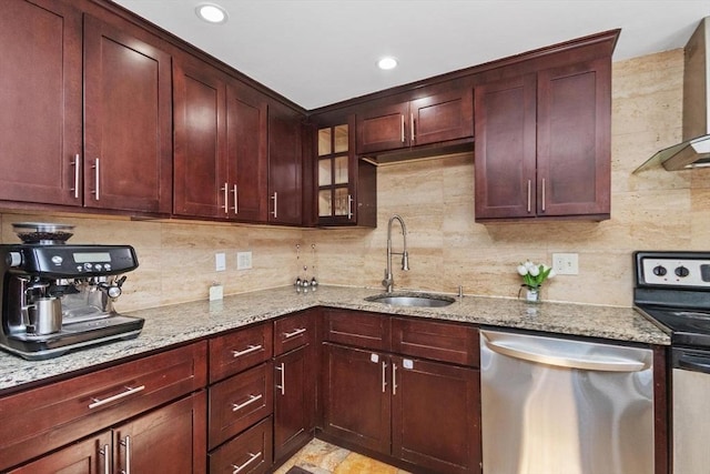 kitchen with light stone counters, decorative backsplash, stainless steel appliances, and a sink