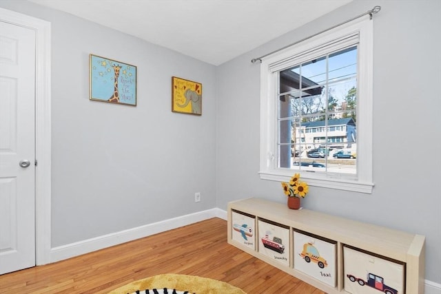 living area with baseboards and light wood-style flooring