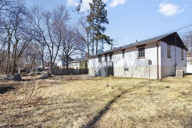 view of yard with cooling unit and fence