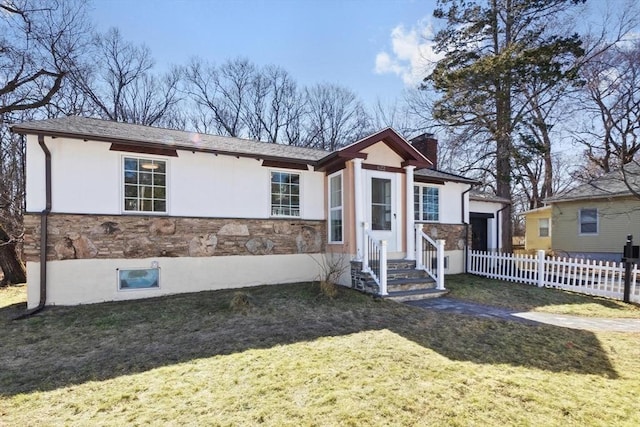 ranch-style house with a front yard, fence, stucco siding, a chimney, and stone siding