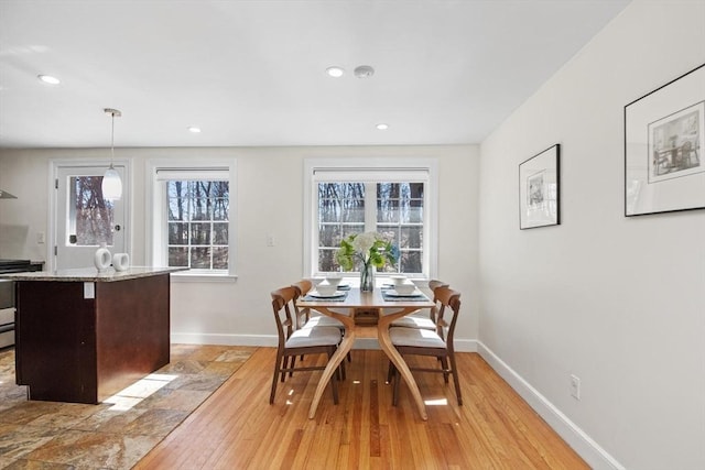 dining space with recessed lighting and baseboards