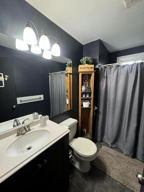 bathroom with tile patterned floors, vanity, and toilet