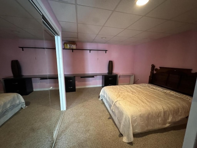 bedroom featuring carpet flooring and a paneled ceiling