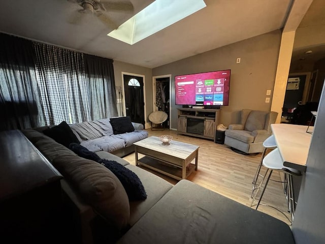 living room with ceiling fan and light hardwood / wood-style flooring