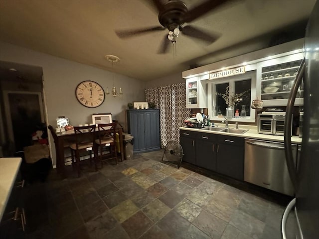 kitchen with stainless steel dishwasher, ceiling fan, and sink